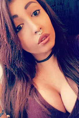 Very busty brunette escort with a nose ring
